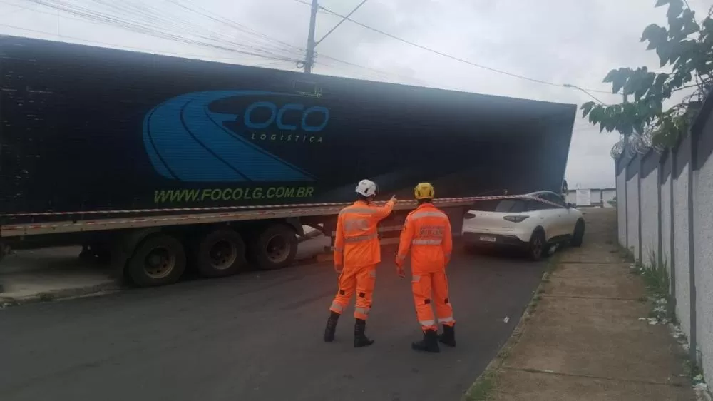 Caminhão tomba sobre veículo e atinge muro de escola infantil